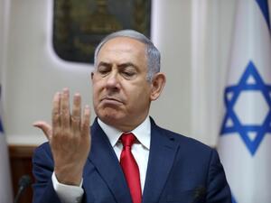 Israeli Prime Minister Benjamin Netanyahu looks at his hand as he chairs the weekly cabinet meeting at his office in Jerusalem on July 7, 2019.  ABIR SULTAN / POOL / AFP