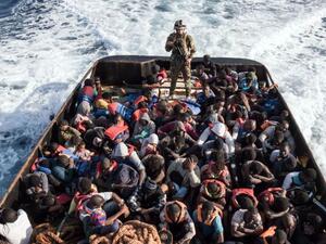 A Libyan coast guard watches over a boat of rescued migrants on  June 27, 2017 /AFP