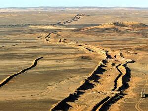 A wall runs through the Western Sahara for over a thousand miles /AFP