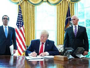 US President Donald Trump signs with US Vice President Mike Pence(R) and US Secretary of Treasury Steven Mnuchin at the White House on June 24, 2019, 'hard-hitting sanctions' on Iran's supreme leader. (MANDEL NGAN / AFP)