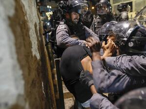 Israeli police detain a Palestinian protester in Jerusalem's Old City