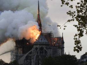 Flames and smoke are seen billowing from the roof at Notre-Dame Cathedral in Paris on April 15, 2019. A fire broke out at the landmark Notre-Dame Cathedral in central Paris, potentially involving renovation works being carried out at the site, the fire service said.