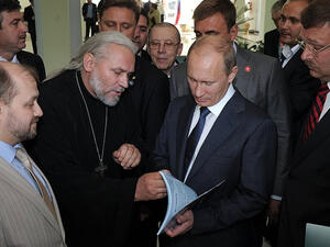 Father Nikolai meets President Vladimir Putin at the 2012 opening of the Russian Centre for Science and Culture in Bethlehem, Palestine.
