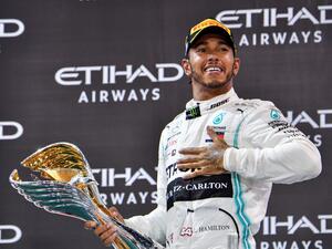 Mercedes' British driver Lewis Hamilton celebrates his win at the Yas Marina Circuit in Abu Dhabi, after the final race of the Formula One Grand Prix season, on December 1, 2019
