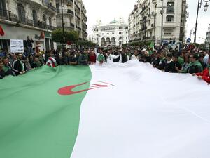 Algerians wave a giant national flag during an anti government demonstration in the capital Algiers, on April 19, 2019. (AFP/ File Photo)