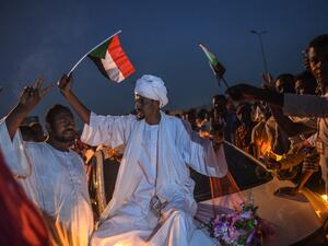 A Sudanese bridegroom waves a Sudan national flag on a wedding car during a protest outside the army complex in the capital Khartoum on April 20, 2019. (AFP)
