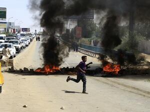 Tires are pictured ablaze during a demonstration in the capital Khartoum on May 13, 2019. (EBRAHIM HAMID / AFP)