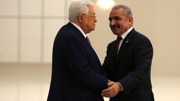 Palestinian Authority President Mahmoud Abbas (L) shakes hands with the prime minister Mohammad Shtayyeh in the West Bank city of Ramallah, on April 13, 2019. (Abbas Momani/AFP)
