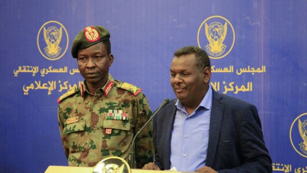 Spokesman of the Sudan's Transitional Military Council Lieutenant General Shamseddine Kabbashi (L) looks on as Sudanese protest leader Madani Abbas Madani speaks during a press conference in Khartoum on May 20, 2019. (AFP)