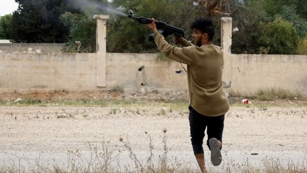 A fighter loyal to the Libyan internationally-recognised Government of National Accord (GNA) fires a Kalashnikov rifle during clashes against forces loyal to strongman Khalifa Haftar, on May 21, 2019. (AFP/ File Photo)