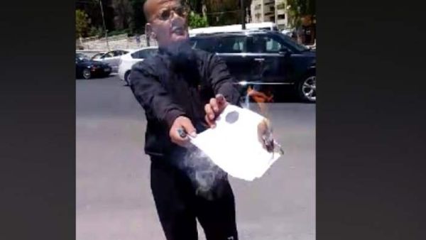 A Jordanian national set fire to his PhD certificate in front of the Prime Ministry building in the capital Amman. (Video Screenshot)
