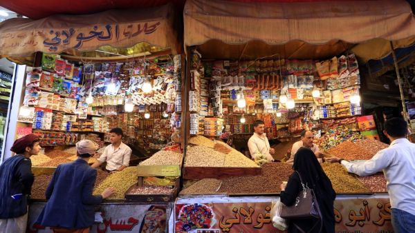 Yemenis shop for sweets and dried fruits in the capital Sanaa on May 28, 2019, during the holy Muslim month of Ramadan and ahead of Eid al-Fitr celebrations. (Mohammed HUWAIS / AFP)