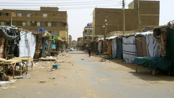 A Sudanese man walks past closed shops and makeshift stalls at the Omdurman market, in Khartoum's twin city on June 9, 2019. (AFP)