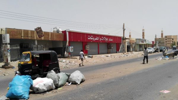 People walk in front of closed shops in the Sudanese capital Khartoum on June 10, 2019, the second day of a nationwide civil disobedience campaign called to pressure the ruling military into handing over power. (AFP/ File Photo)