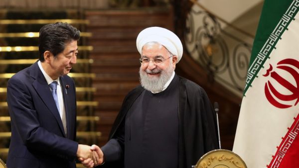 Iranian President Hassan Rouhani (R) shakes hands with Japanese Prime Minister Shinzo Abe, at the Saadabad Palace in the capital Tehran on June 12, 2019. (AFP/ File Photo)