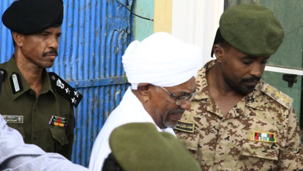 Ousted Sudanese leader Omar al-Bashir is escorted before being driven in an armed convoy from the Kober prison to the prosecutor's office in North Khartoum on June 16, 2019.  (AFP/ File Photo)