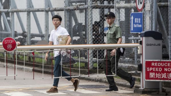 Hong Kong democracy activist Joshua Wong (L) leaves Lai Chi Kok Correctional Institute in Hong Kong on June 17, 2019. Wong called on the city's pro-Beijing leader Carrie Lam to resign after he walked free from prison, as historic anti-government protests rocked the city. (ISAAC LAWRENCE / AFP)