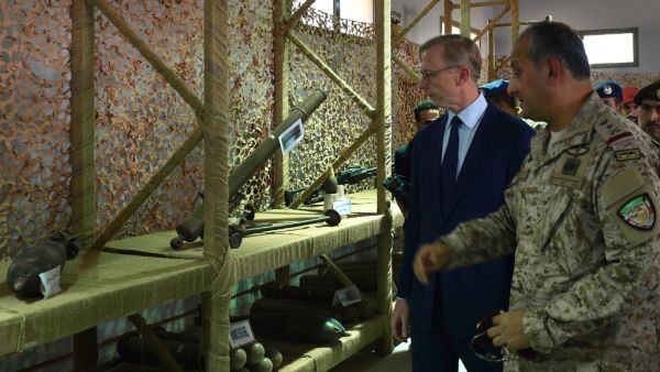 Brian Hook (R), the US special representative on Iran, walks past what Saudi officials said were Iranian-made weapons used by the Huthi rebels in Yemen, during a visit to an army base in al-Kharj, south of the Saudi capital Riyadh, on June 21, 2019. (AFP)