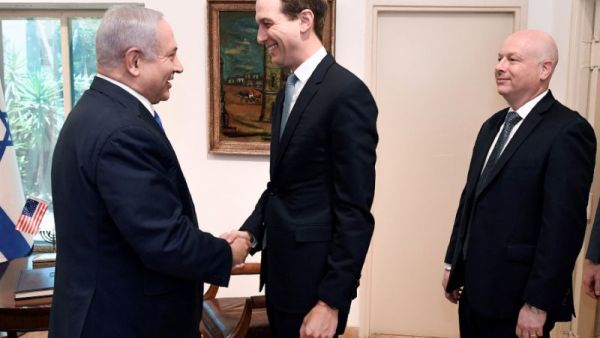 US President Donald Trump's son-in-law and adviser Jared Kushner shakes hands with Israeli Prime Minister Benjamin Netanyahu during a meeting in Jerusalem, with Trump's aide for international negotiations Jason Greenblatt looking on (AFP Photo)