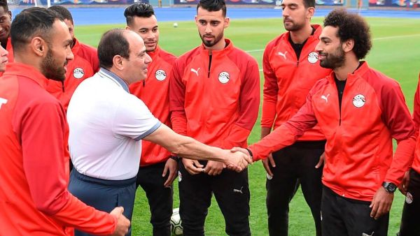 Egyptian President Abdel Fattah El Sisi greets Egypt's UEFA Champions League winning Liverpool forward Mohamed Salah during the national team's training camp at the 30 June Stadium in Cairo on June 15, 2019. (AFP)