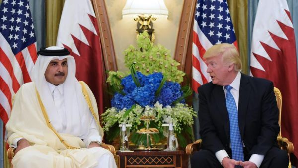 US President Donald Trump (R) speaks with Qatar's Emir Sheikh Tamim Bin Hamad Al-Thani, during a bilateral meeting at a hotel in the Saudi capital Riyadh.(AFP Photo)