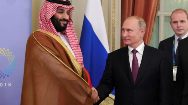 This week’s OPEC+ meeting could see another friendly handshake between Saudi Arabian Crown Prince Mohammed bin Salman and Russian President Vladimir Putin, pictured here on Dec. 1. (Mikhail Klimentyev/AFP/Getty Images) 