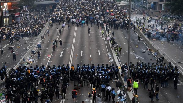 Police clash with protesters during a rally against a controversial extradition law proposal outside the government headquarters in Hong Kong (AFP)  