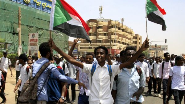 Sudanese students wave national flags as they protest in the capital Khartoum on July 30, 2019, a day after teenagers were shot at a rally. (AFP/ File Photo)