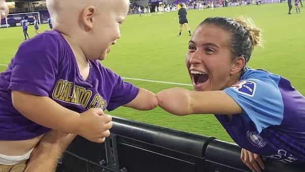 Little 18-month-old Joseph Tidd (left) who was born without his left hand has warmed hearts everywhere after he 'fist bump' his limb with football star Carson Pickett (right) who suffers from the same condition. (Instagram)