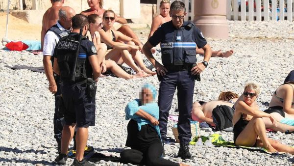 Police in France in 2016 policing what Muslim women wear at a beach. (AFP)