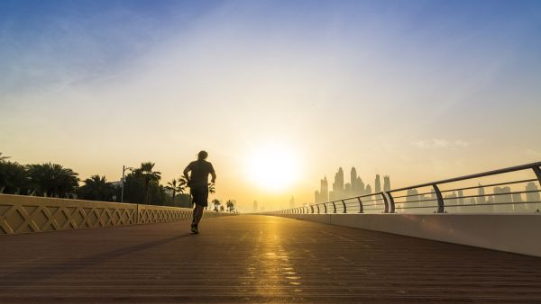 Man running with Dubai Skyline in background