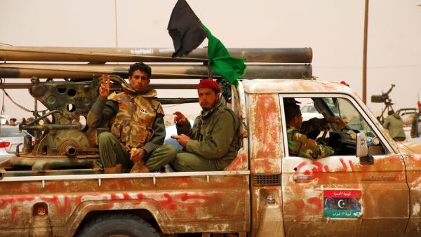 Libyan rebels travel to a battle (Shutterstock)	