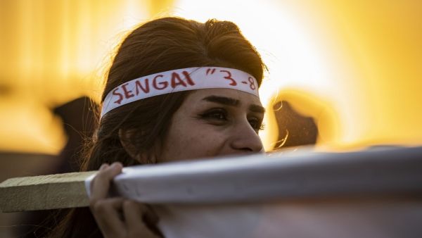 A Syrian Yazidi woman takes part in a demonstration in the northeastern town of Amude, about 28 kilometres west of Qamishli near the Syrian-Turkish border (AFP)