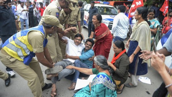 Members of the Communist Party of India are detained by police at a protest in Hyderabad (AFP)