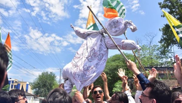 Pakistani Kashmiri hold an effigy of Indian Prime Minister Narendra Modi during a protest in Muzaffarabad, the capital of Pakistan-controlled Kashmir, on August 8, 2019. 