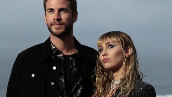 US singer Miley Cyrus and husband Australian actor Liam Hemsworth arrive for the Saint Laurent Men's Spring-Summer 2020 runway show in Malibu, California. (AFP/ File)