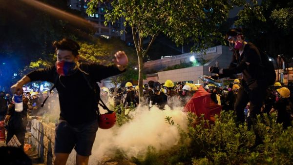 Police in Hong Kong fired volleys of tear gas on August 11 at thousands of pro-democracy protesters who defied warnings from authorities to hit the streets for the tenth weekend in a row. (Manan VATSYAYANA / AFP)
