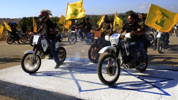 Hezbollah members ride their motorcycles in the Lebanese village of Aitaroun (AFP)