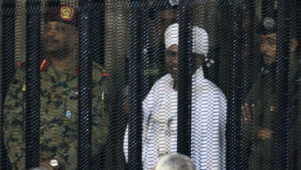 Sudan's deposed military ruler Omar al-Bashir stands in a defendant's cage during the opening of his corruption trial in Khartoum on August 19, 2019. (AFP/ File Photo)