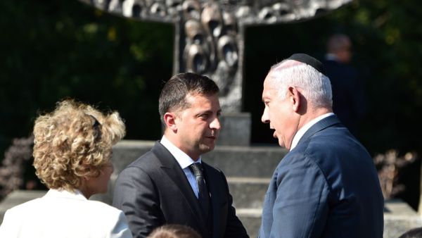 Ukrainian President Volodymyr Zelensky (L) and Prime Minister of Israel Benjamin Netanyahu (R) attend a memorial ceremony in front of menorah at The Babyn Yar Holocaust Memorial Centre. (AFP/ File Photo)