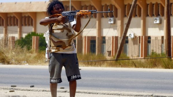 A fighter loyal to the internationally-recognised Government of National Accord (GNA) points his gun toward enemy lines during clashes with forces loyal to strongman Khalifa Haftar, in Espiaa. (AFP/ File Photo)