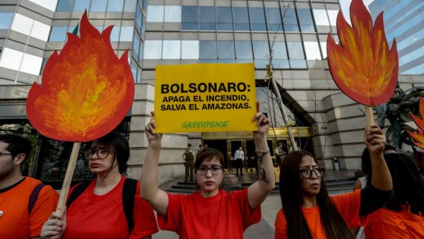 Activists demonstrate during a protest against the government of Brazil's President Jair Bolsonaro over the fires in the Amazon rainforest in front of Brazil's Embassy in Santiago on August 23, 2019. (AFP/ File Photo)