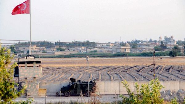 A Turkish military truck patrols next to a Turkish national flag hoisted at the border with Syria on August 14, 2019, in Akcakale, in Sanliurfa, southeastern Turkey. (AFP)