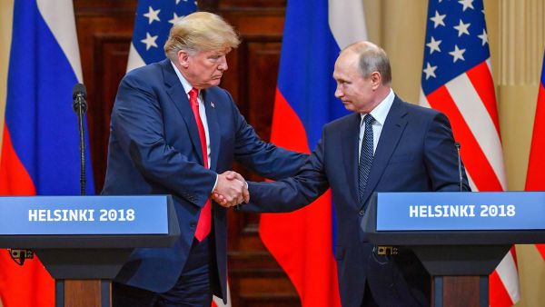 US President Donald Trump shakes hands with Russian President Vladimir Putin at the end of their summit in Helsinki, Finland, on Monday, July 16. (Yuri Kadobnov/AFP/Getty Images)