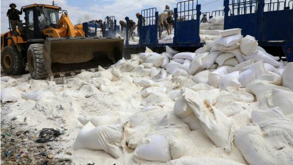 The Houthis used diggers to break up sacks of maggot-ridden rice and flour. (AFP/ File Photo)