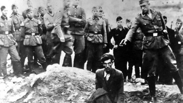 Amazon has removed an assortment of clothes sold on its UK site emblazoned with a notorious Holocaust photo in which a Jew in Ukraine is kneeling in front of a mass grave as a Nazi officer points a gun to his head, moments before shooting him (Twitter)