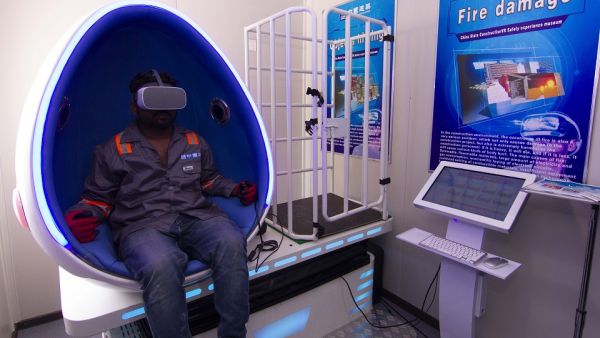 Construction workers experience simulated hazard - management training in the Virtual Reality Pods at DAMAC's AYKON City. Construction workers experience simulated hazard - management training in the Virtual Reality Pods at DAMAC's AYKON City.