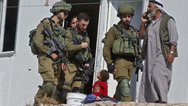 Israeli forces evict Palestinians from mobile homes built by EU funding and undergoing Israeli demolition in the village of Mufagara south of Yatta near Hebron in the occupied West Bank on September 11, 2019. (AFP/ File Photo)