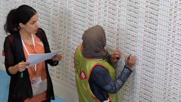 Staff members of Tunisia's Independent Higher Authority for Elections (ISIE) tally votes as they prepare the results of the presidential vote at a sorting center in Ariana, north of the capital Tunis on September 16, 2019. (AFP/ File Photo)