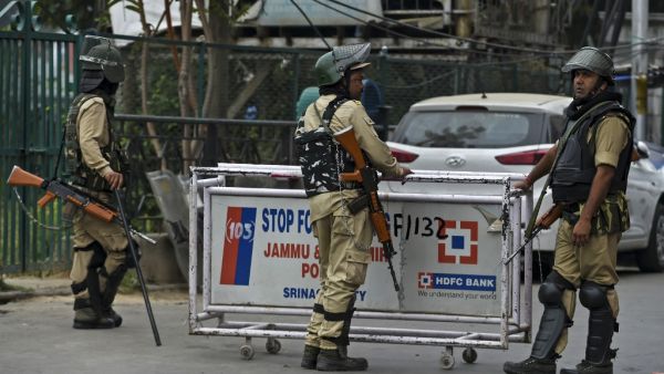 Security personnel stand guard to block a road while strict restrictions are imposed during a lockdown in Srinagar on September 28, 2019. Tauseef MUSTAFA / AFP